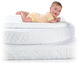 baby on pile of mattresses